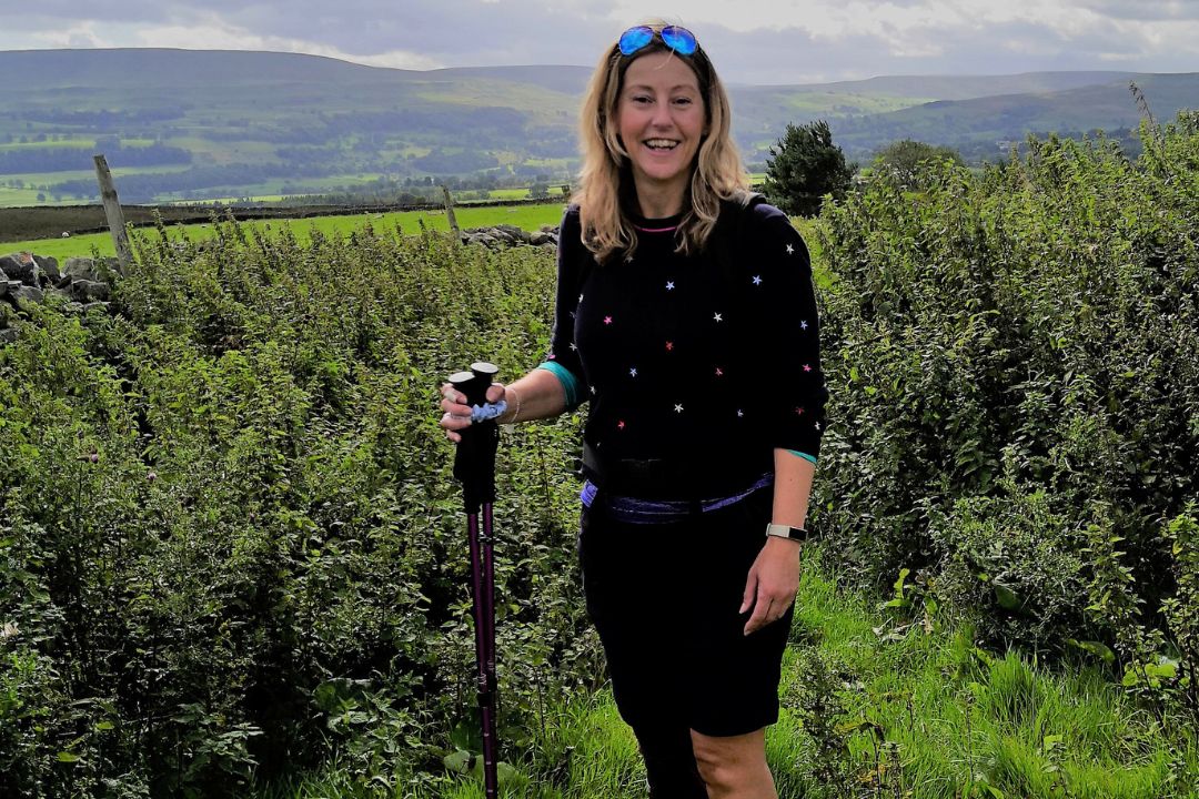 Hil Mines, founder of walking for charity app trundle, walks in the countryside with the help of walking poles